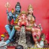 Colorful statues of Hindu gods Ganesh, Shiva, and Parvati in Thai temple setting.